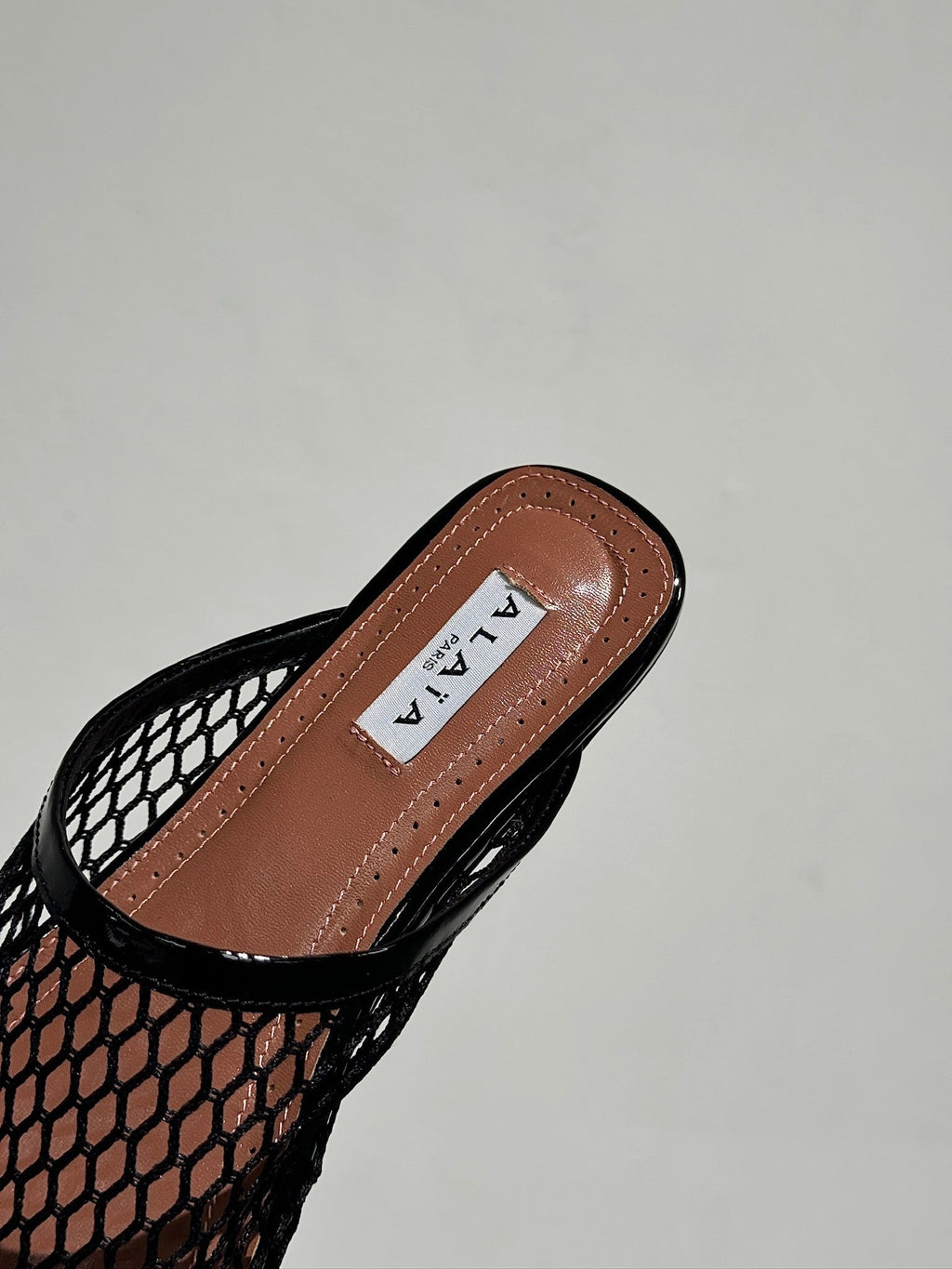 ALAIA FLAT MULES IN BLACK MESH FISHNET