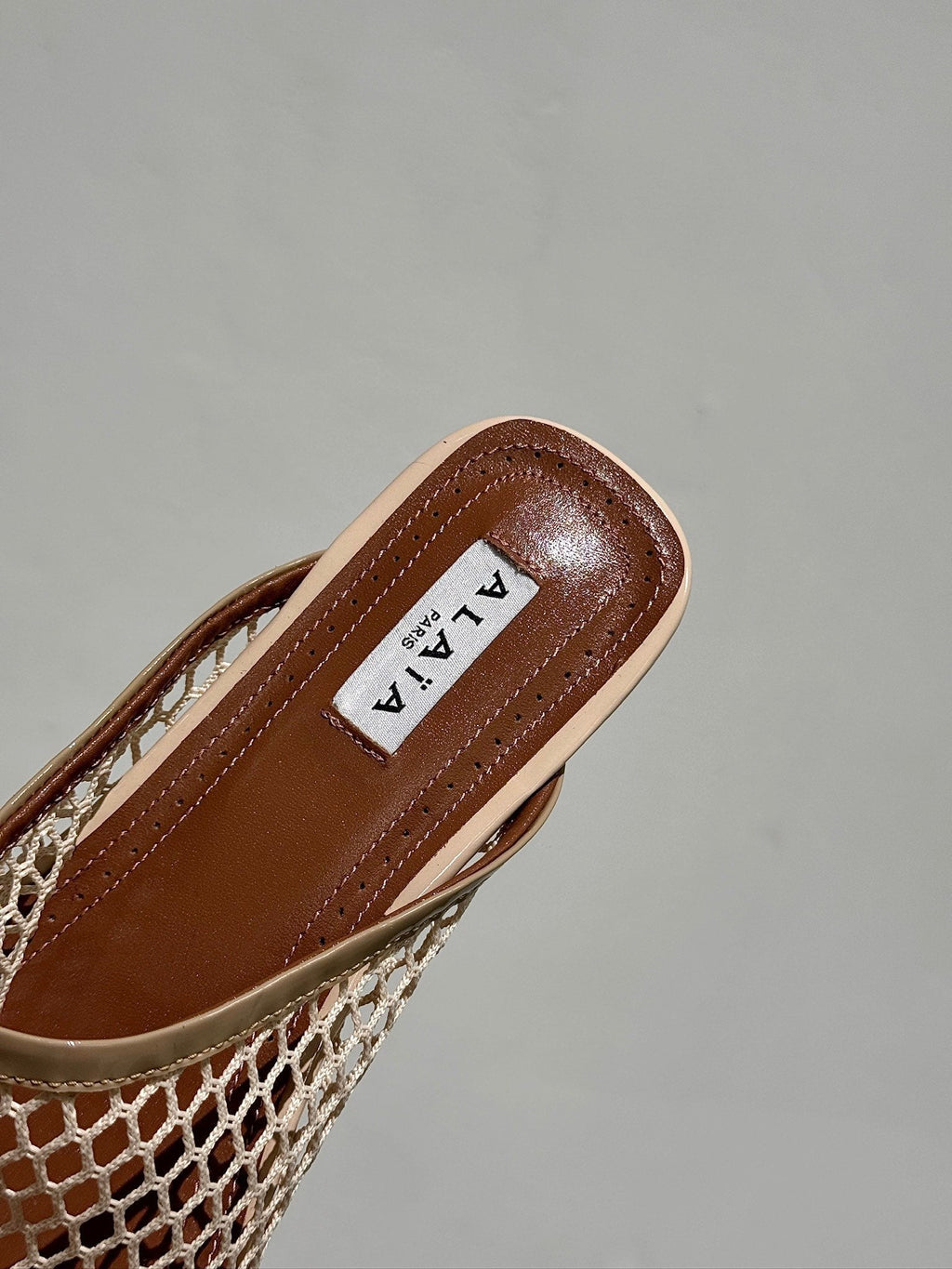 ALAIA FLAT MULES IN BEIGE MESH FISHNET
