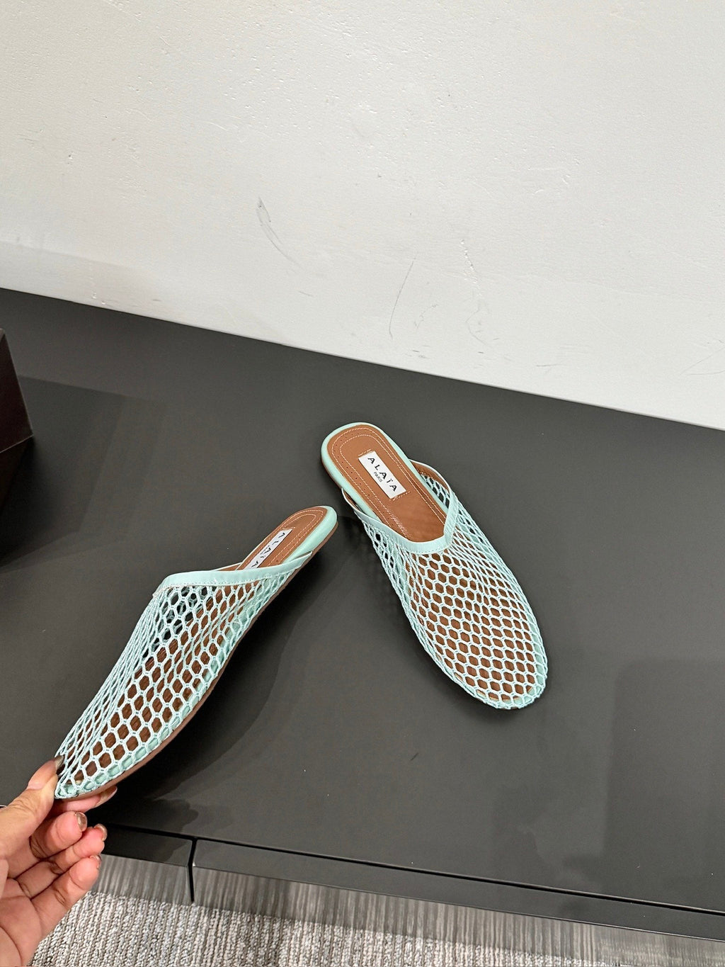 ALAIA FLAT MULES IN LIGHT BLUE MESH FISHNET