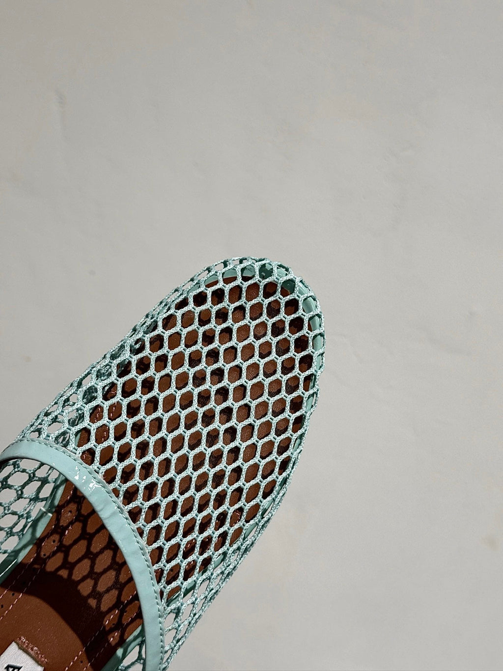 ALAIA FLAT MULES IN LIGHT BLUE MESH FISHNET