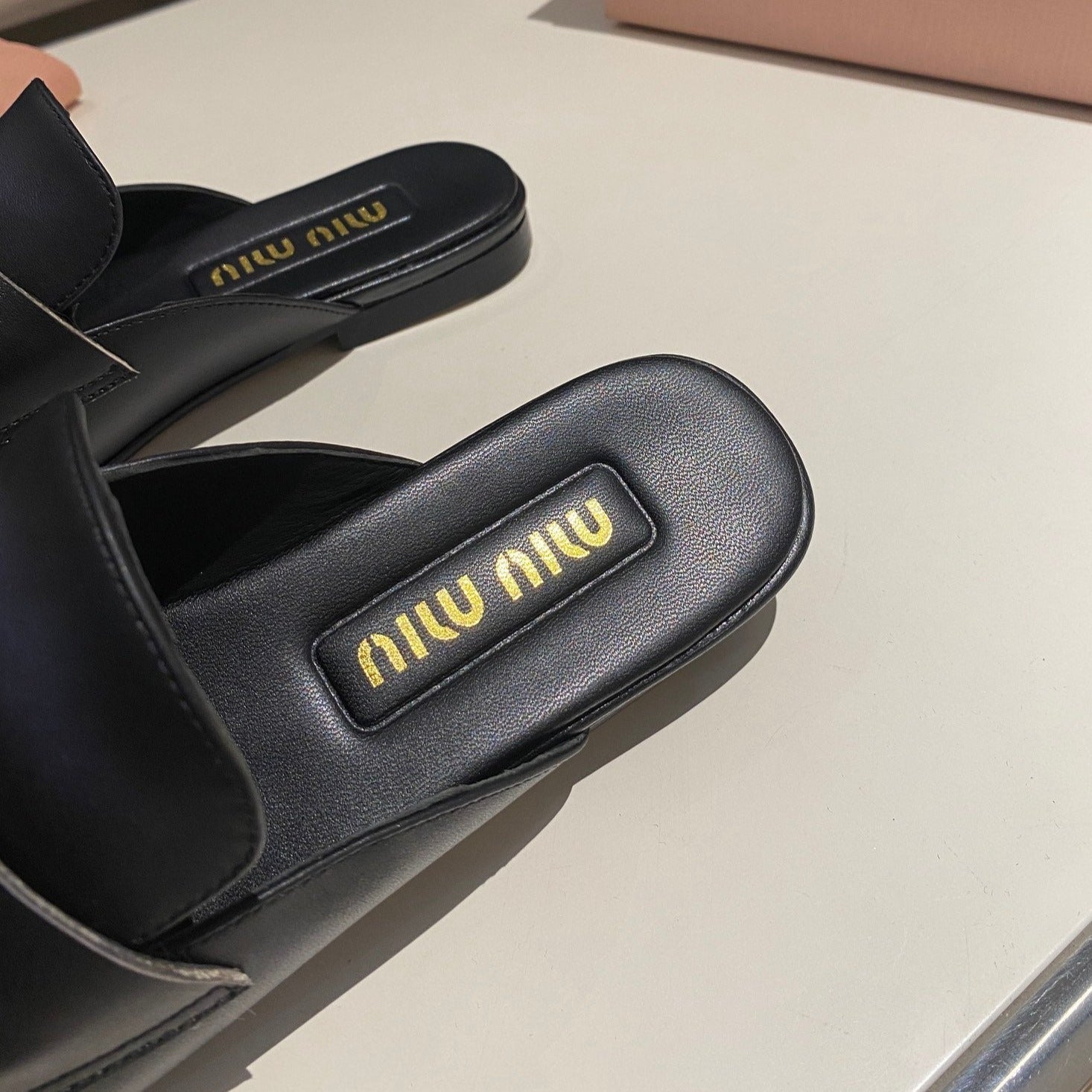 MULES SLIPPERS BLACK COWHIDE WITH GOLD COIN