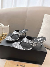 ALAIA HEELED THONG SANDALS 25S 55MM IN WHITE AND BLACK LAMBSKIN SNAKE-EMBOSSED