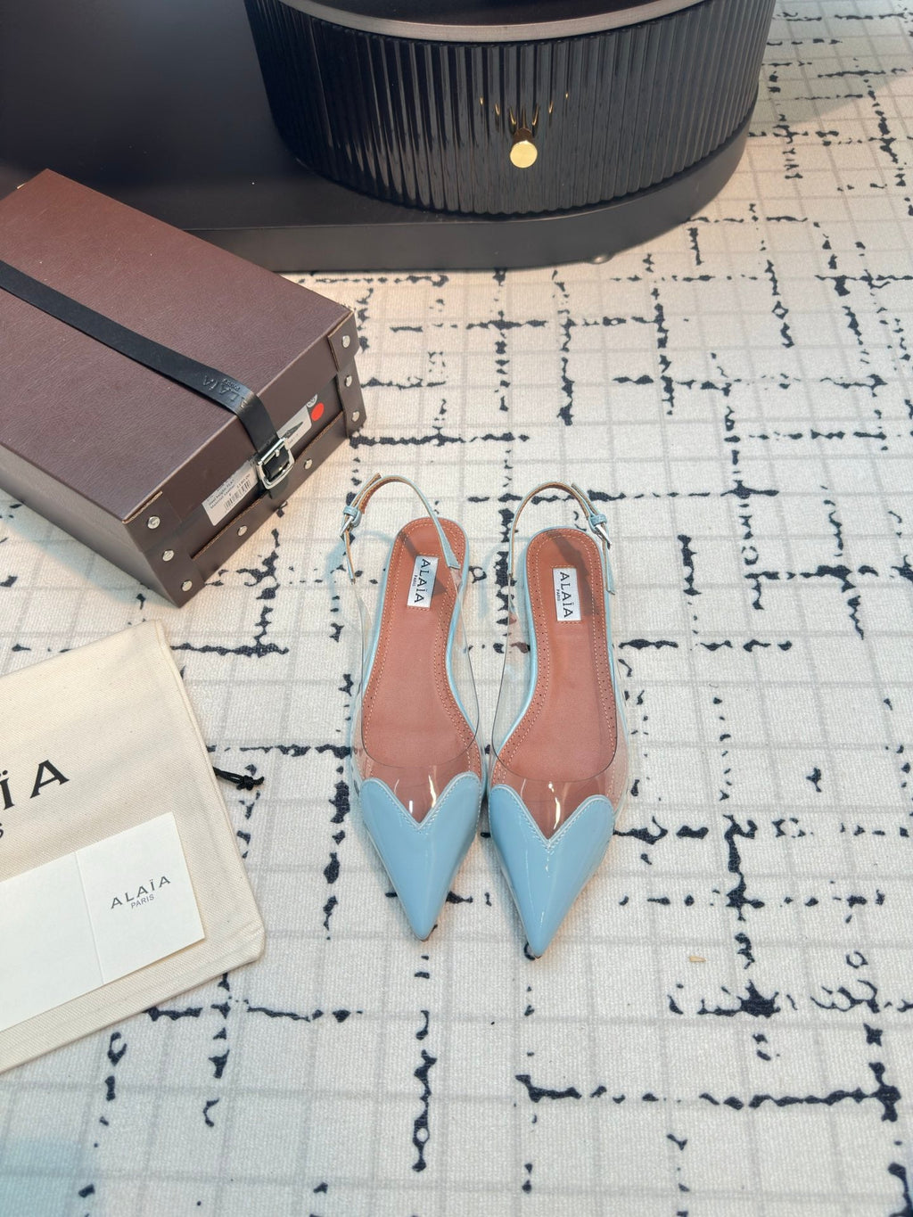 ALAIA FLAT SLINGBACK IN LIGHT BLUE PATENT CALFSKIN AND FILM