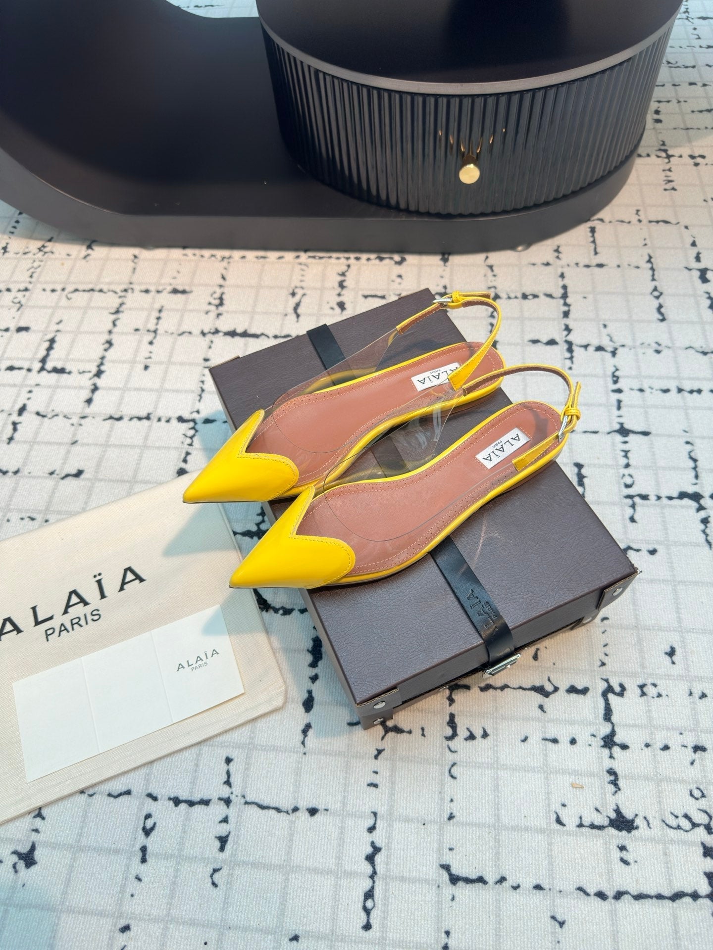 ALAIA FLAT SLINGBACK IN YELLOW PATENT CALFSKIN AND FILM