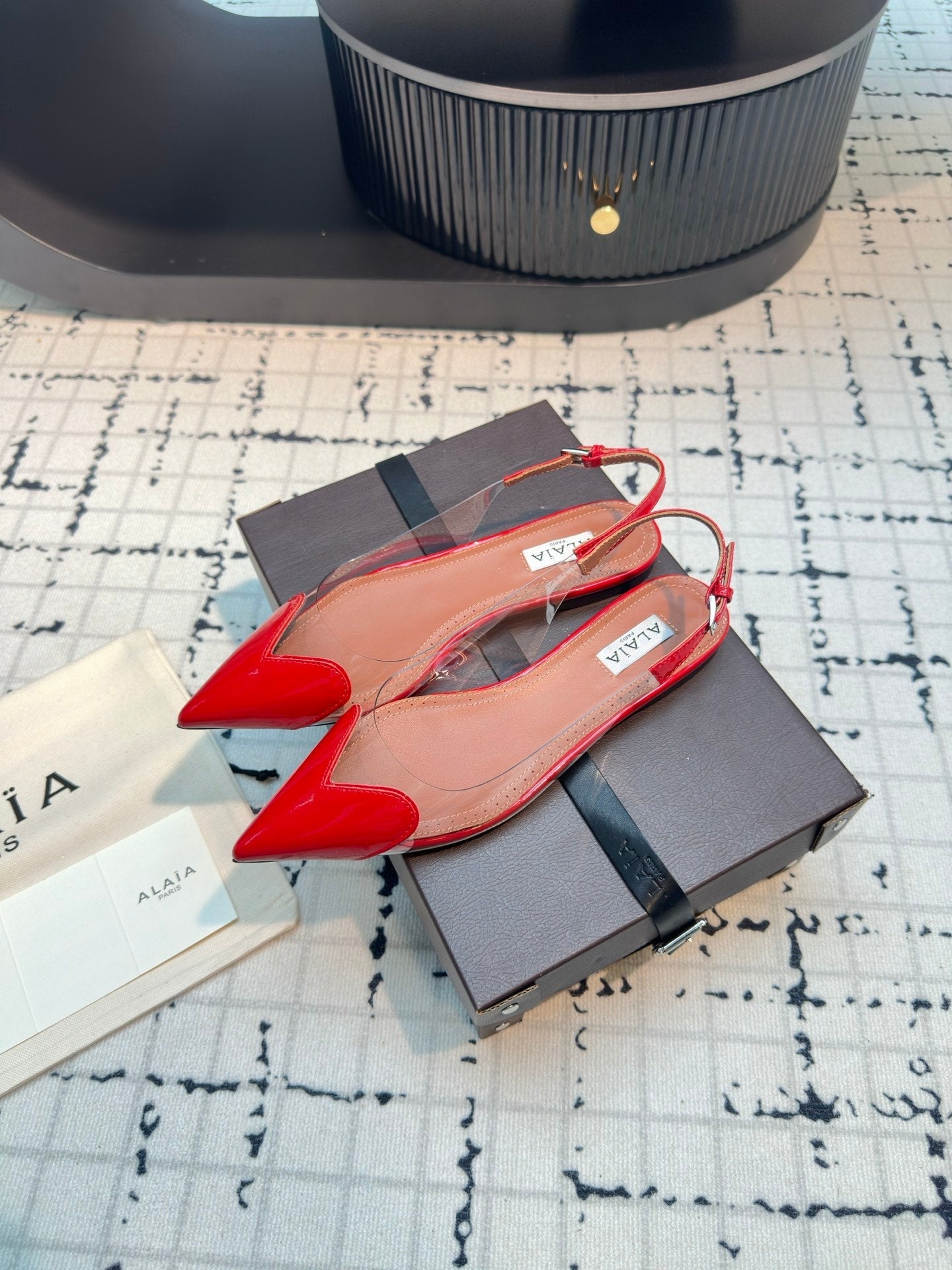 ALAIA FLAT SLINGBACK IN CHERRY RED PATENT CALFSKIN AND FILM