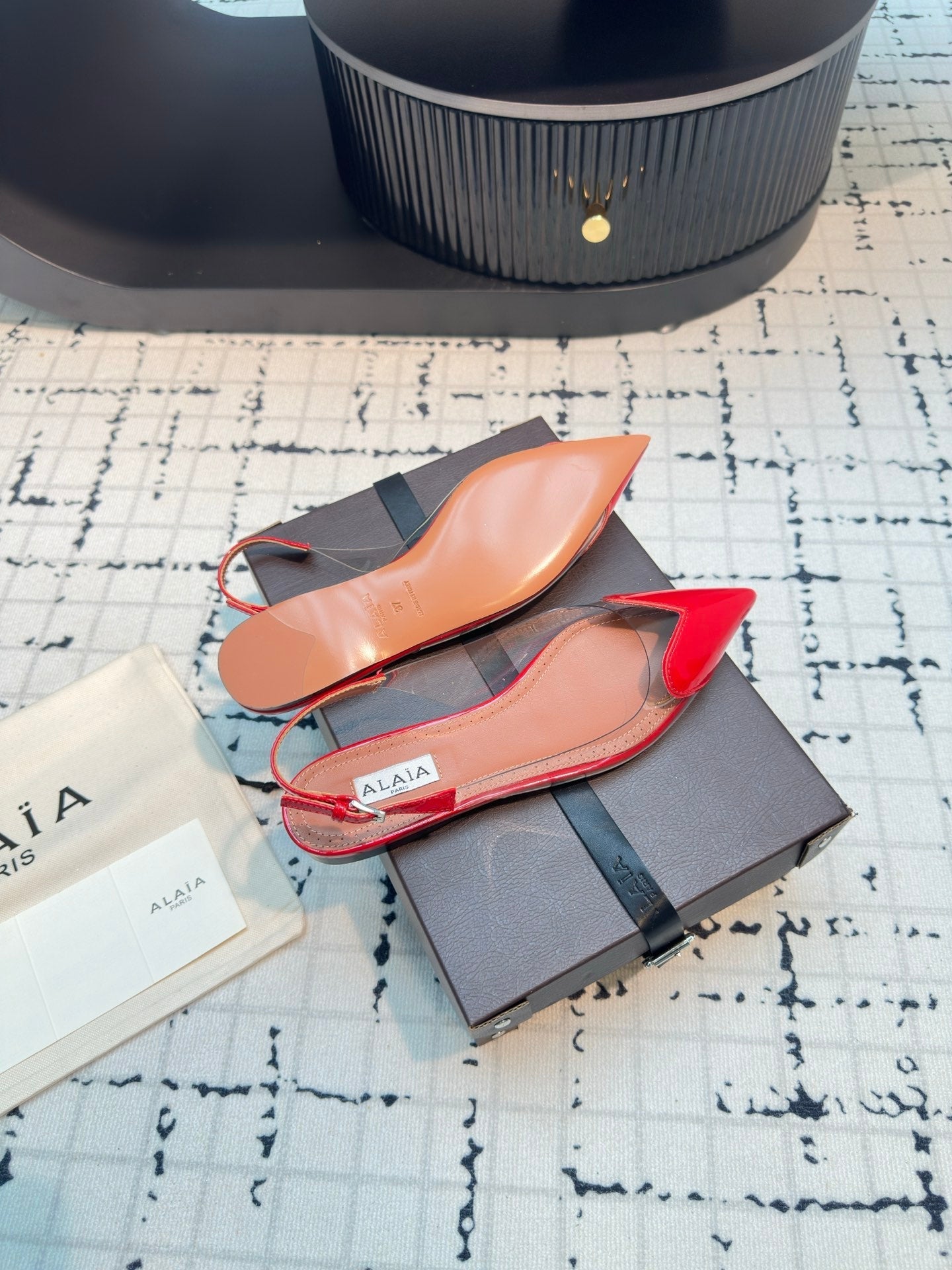 ALAIA FLAT SLINGBACK IN CHERRY RED PATENT CALFSKIN AND FILM