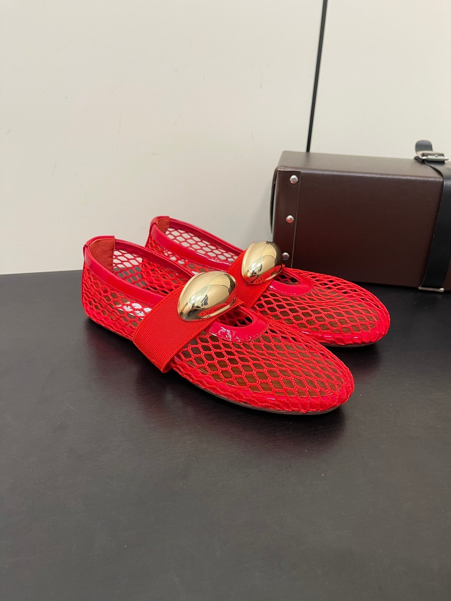 ALAIA BALLET FLATS IN CHERRY RED MESH FISHNET WITH GOLD HARDWARE