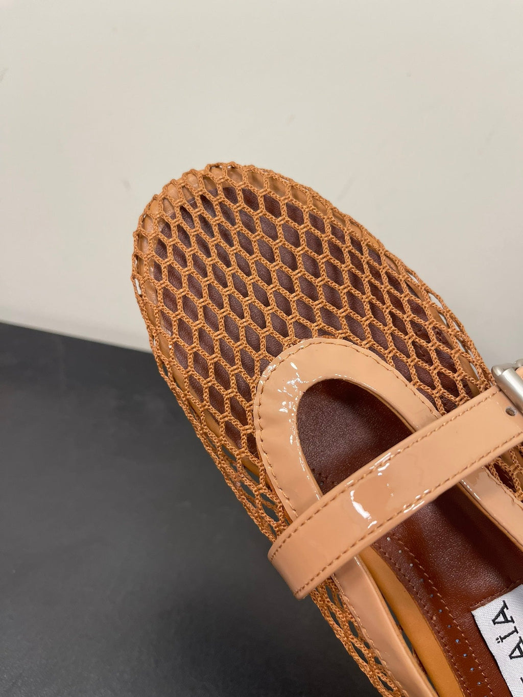 ALAIA BALLET FLATS IN COPPER BROWN MESH FISHNET