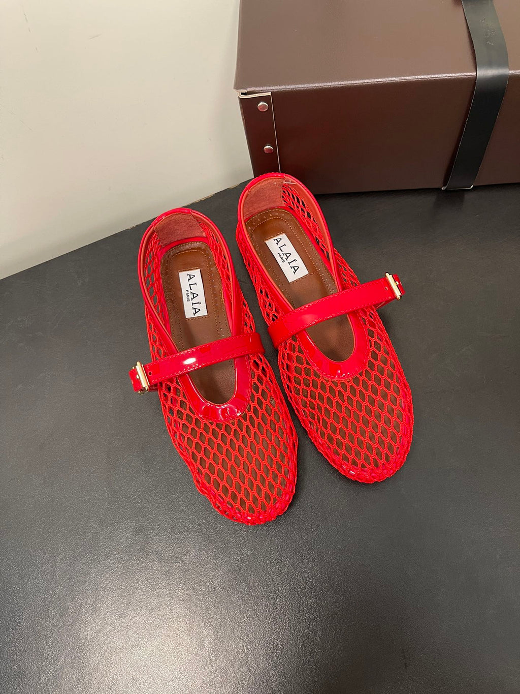 ALAIA BALLET FLATS IN CHERRY RED MESH FISHNET