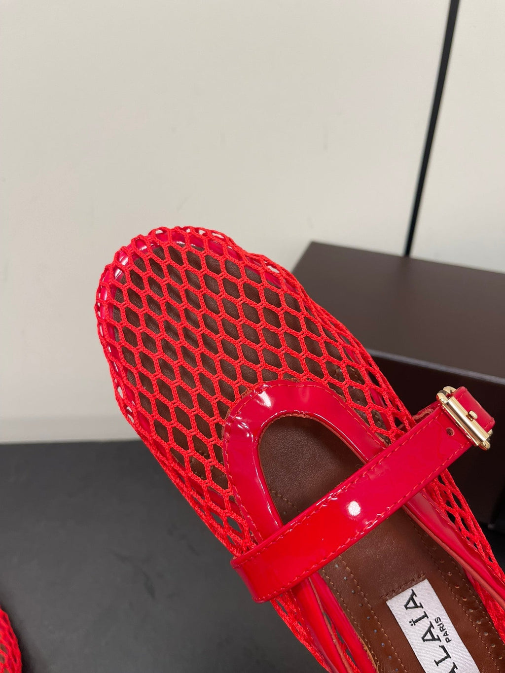 ALAIA BALLET FLATS IN CHERRY RED MESH FISHNET