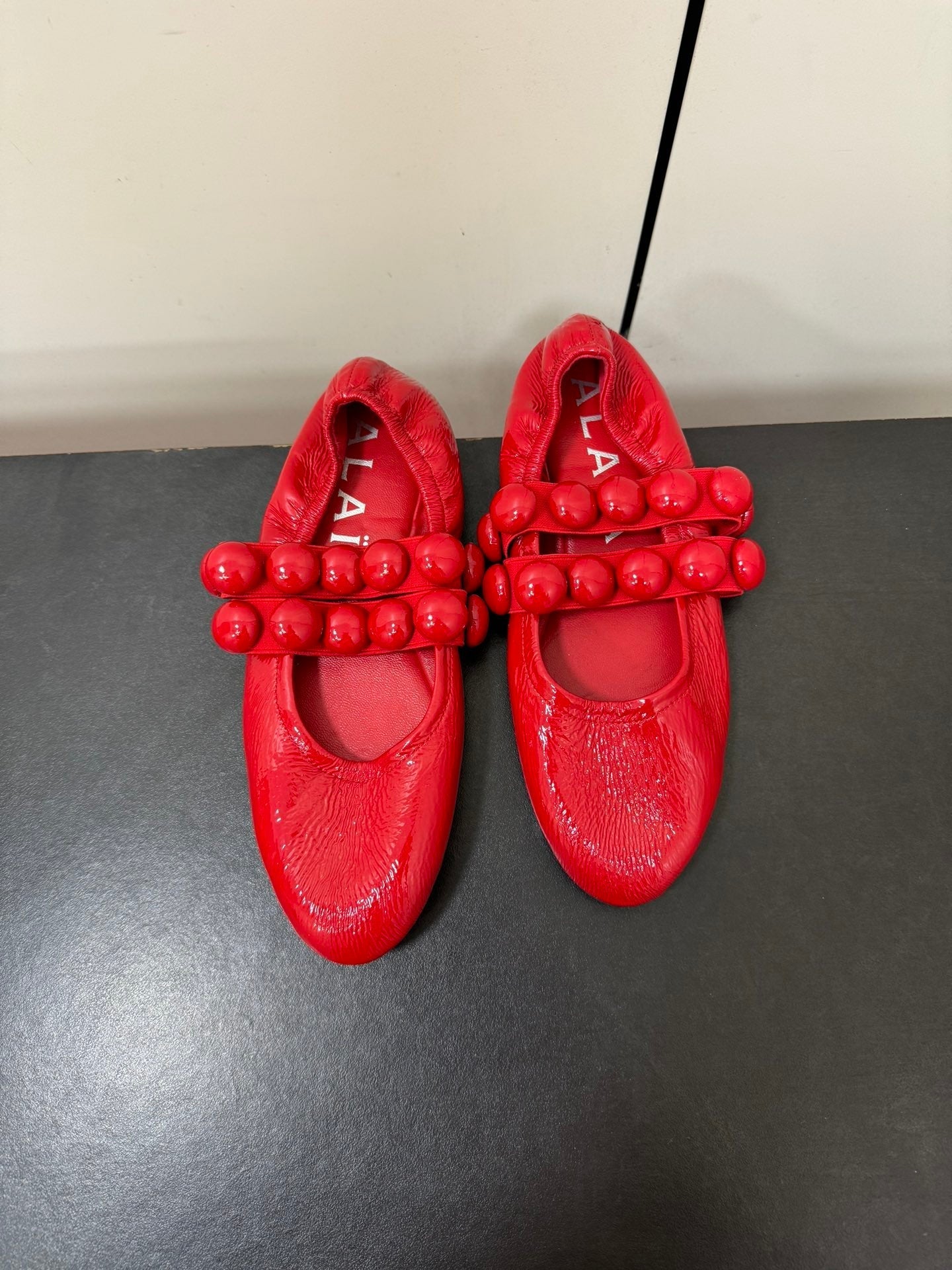 ALAIA SPHERE BALLET FLATS IN CHERRY RED LAMBSKIN