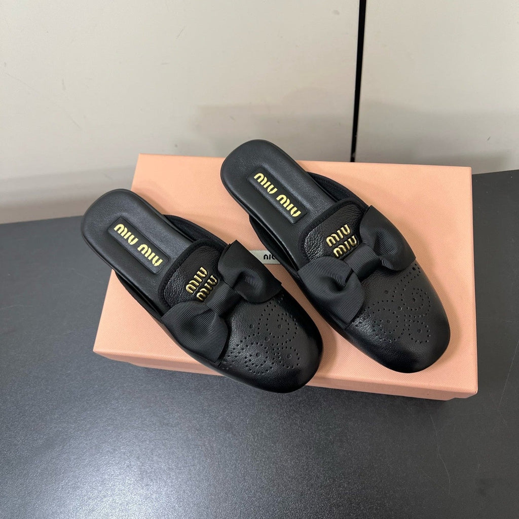 BOW MULES IN BLACK SHEEPSKIN