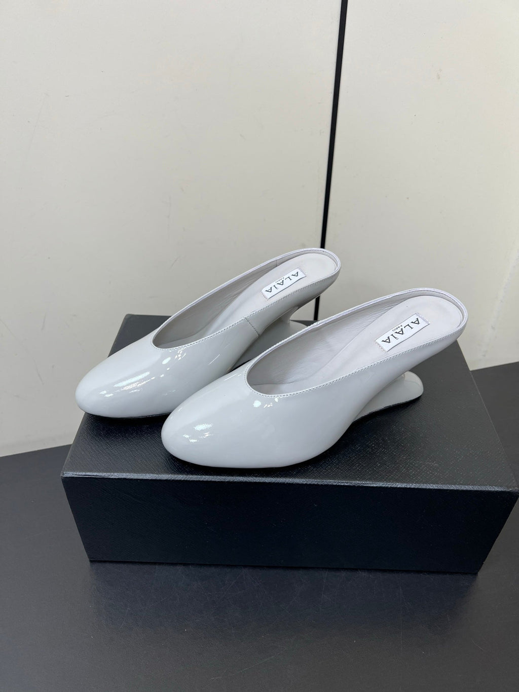 ALAIA WEDGE MULES 25S IN WHITE LAMBSKIN