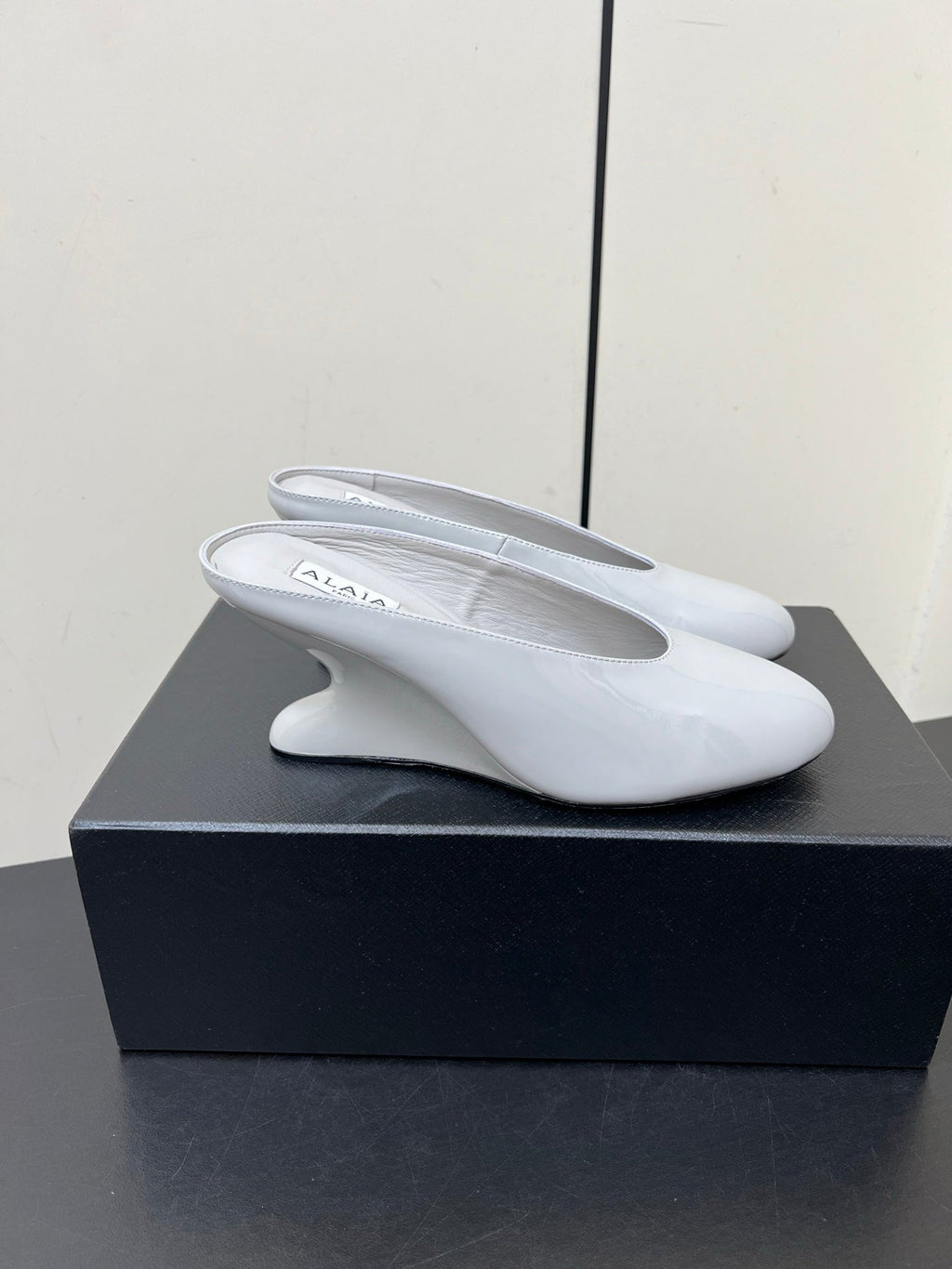 ALAIA WEDGE MULES 25S IN WHITE LAMBSKIN