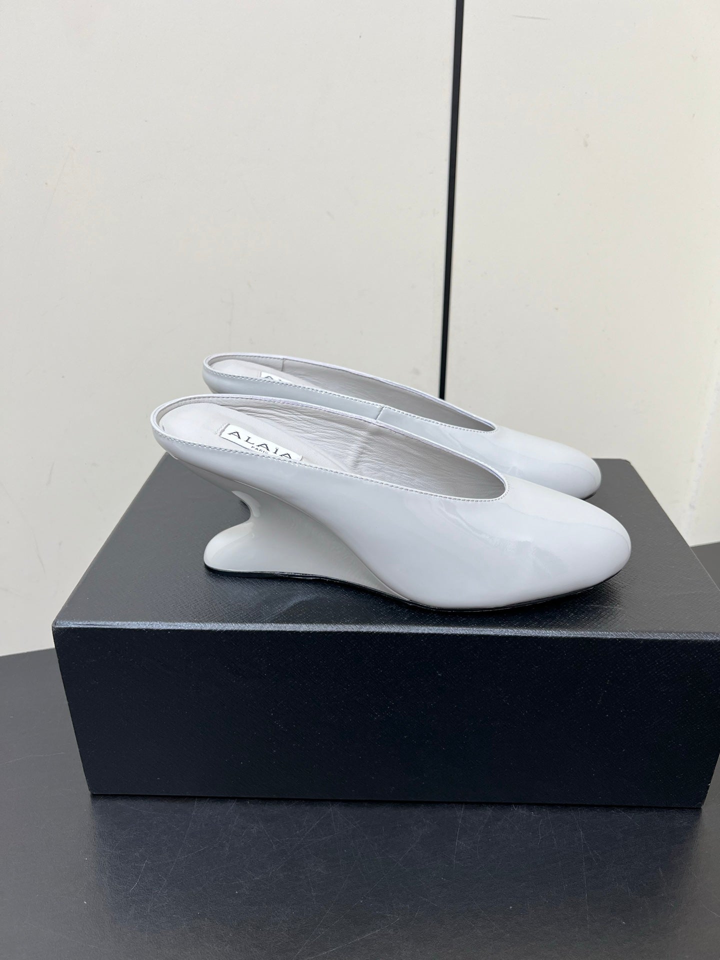 ALAIA WEDGE MULES 25S IN WHITE LAMBSKIN