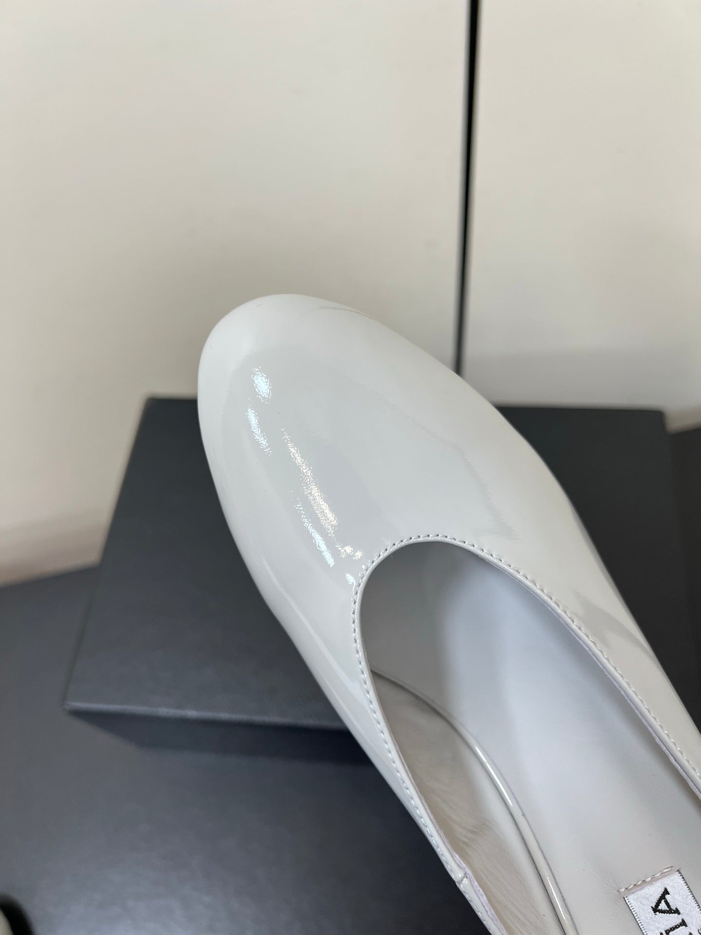 ALAIA WEDGE MULES 25S IN WHITE LAMBSKIN