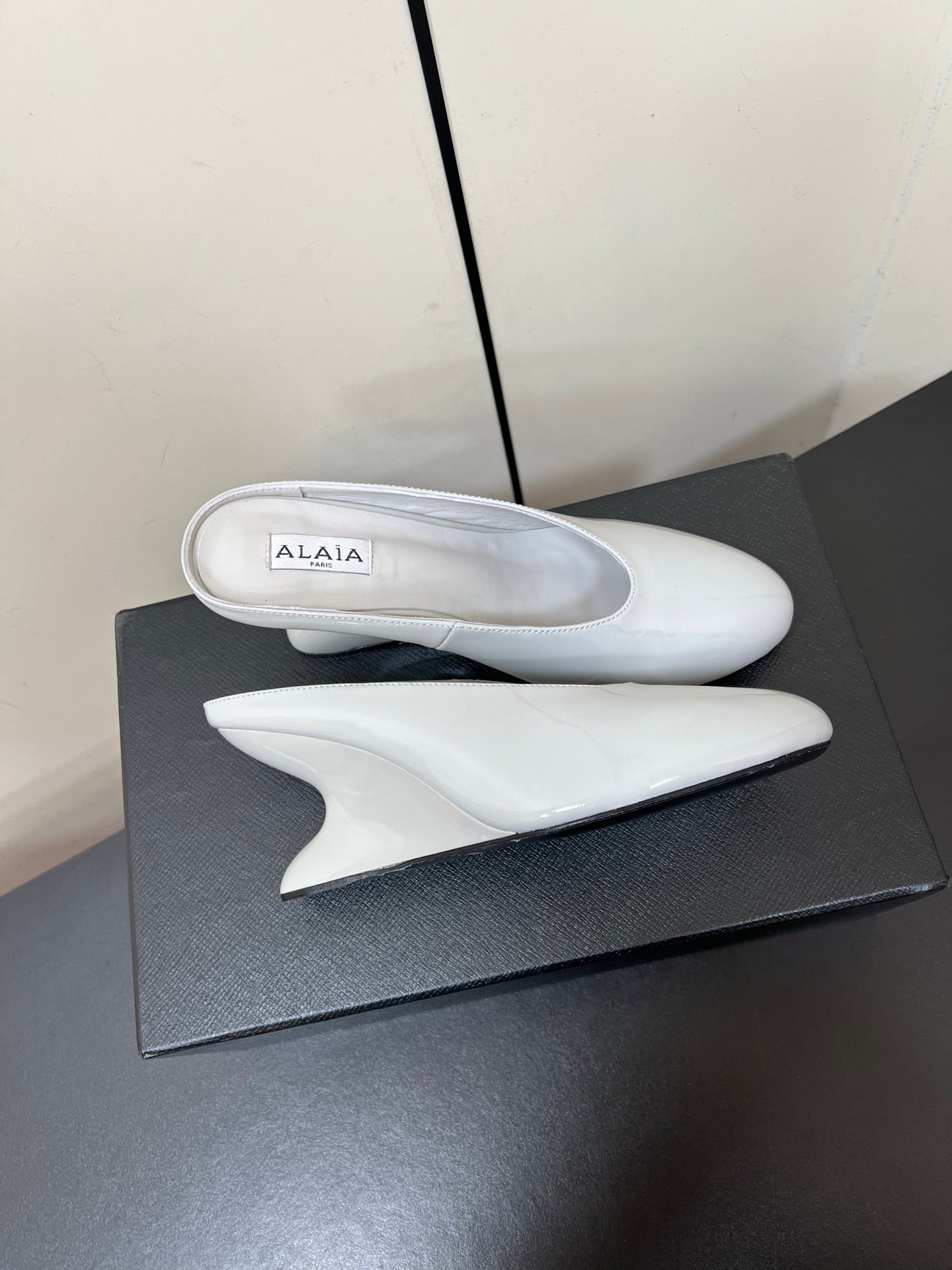 ALAIA WEDGE MULES 25S IN WHITE LAMBSKIN