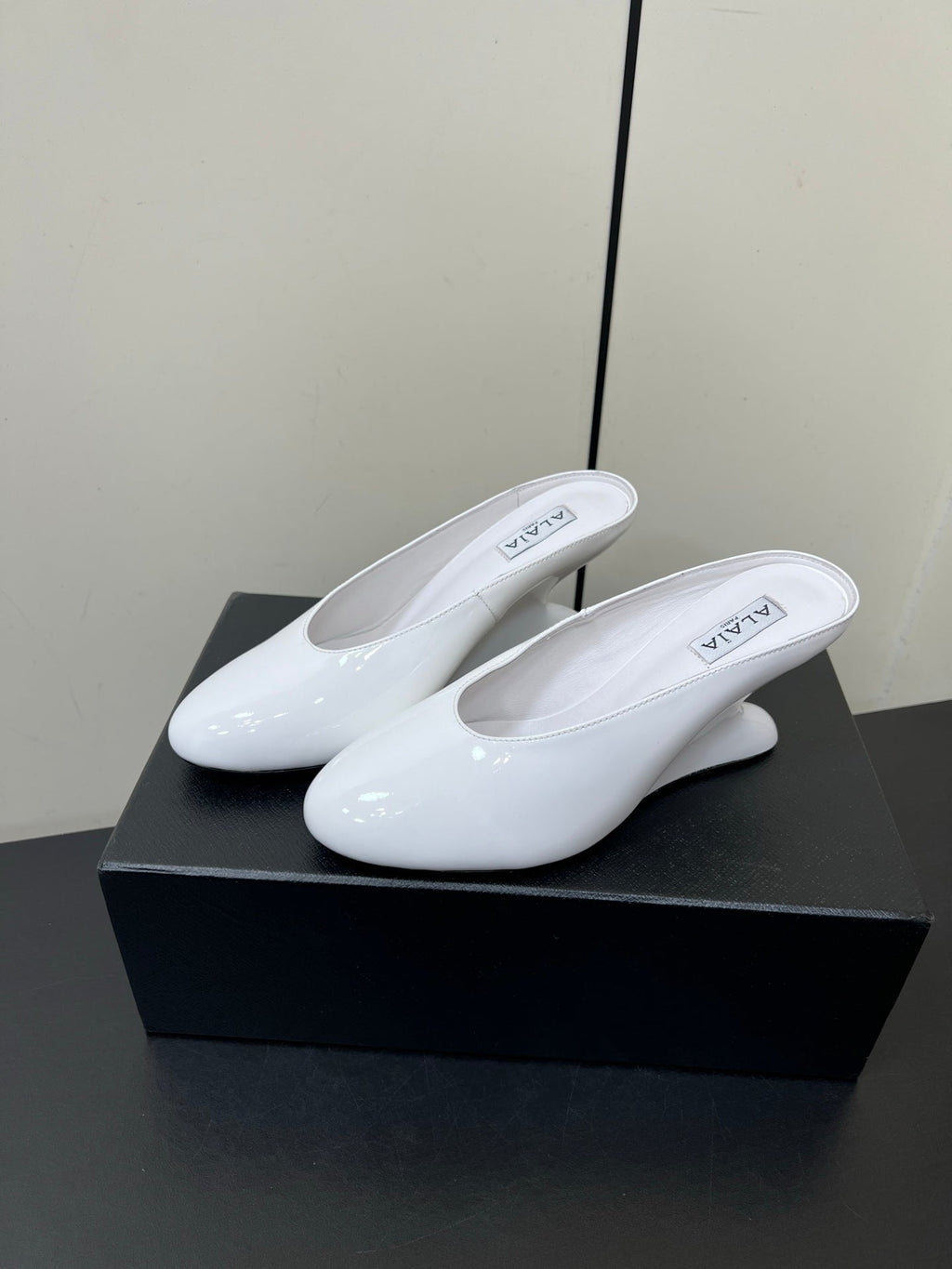 ALAIA WEDGE MULES 25S IN CREAM WHITE LAMBSKIN