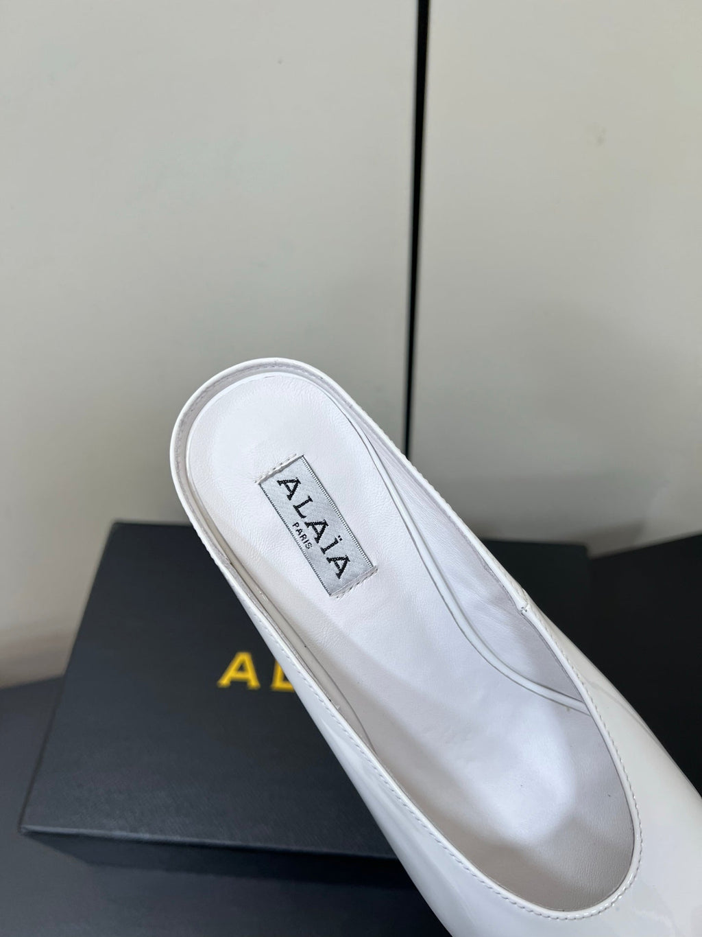 ALAIA WEDGE MULES 25S IN CREAM WHITE LAMBSKIN