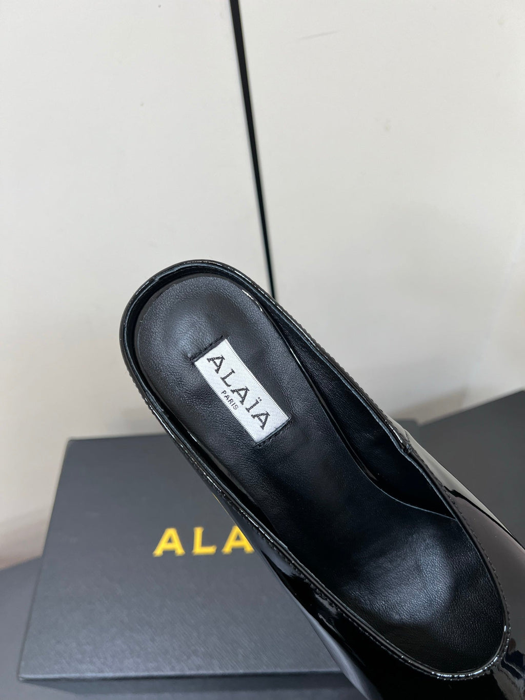 ALAIA WEDGE MULES 25S IN BLACK LAMBSKIN