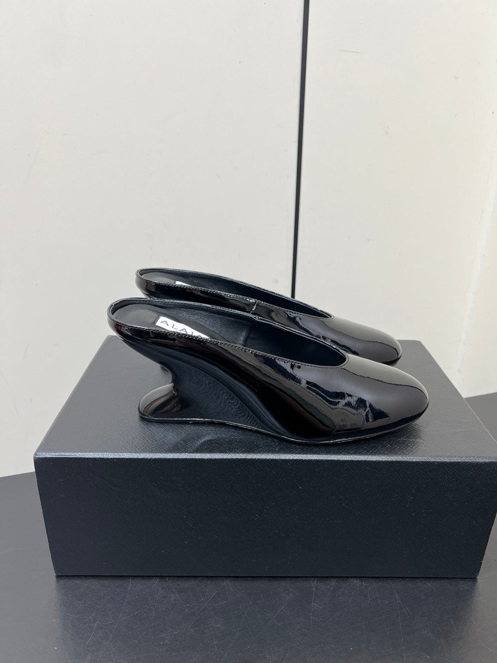 ALAIA WEDGE MULES 25S IN BLACK LAMBSKIN