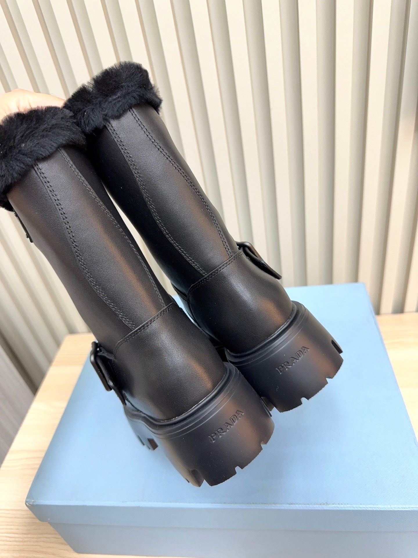 PRADA 25S MARTIN BOOTS IN BLACK CALFSKIN FUR-LINED