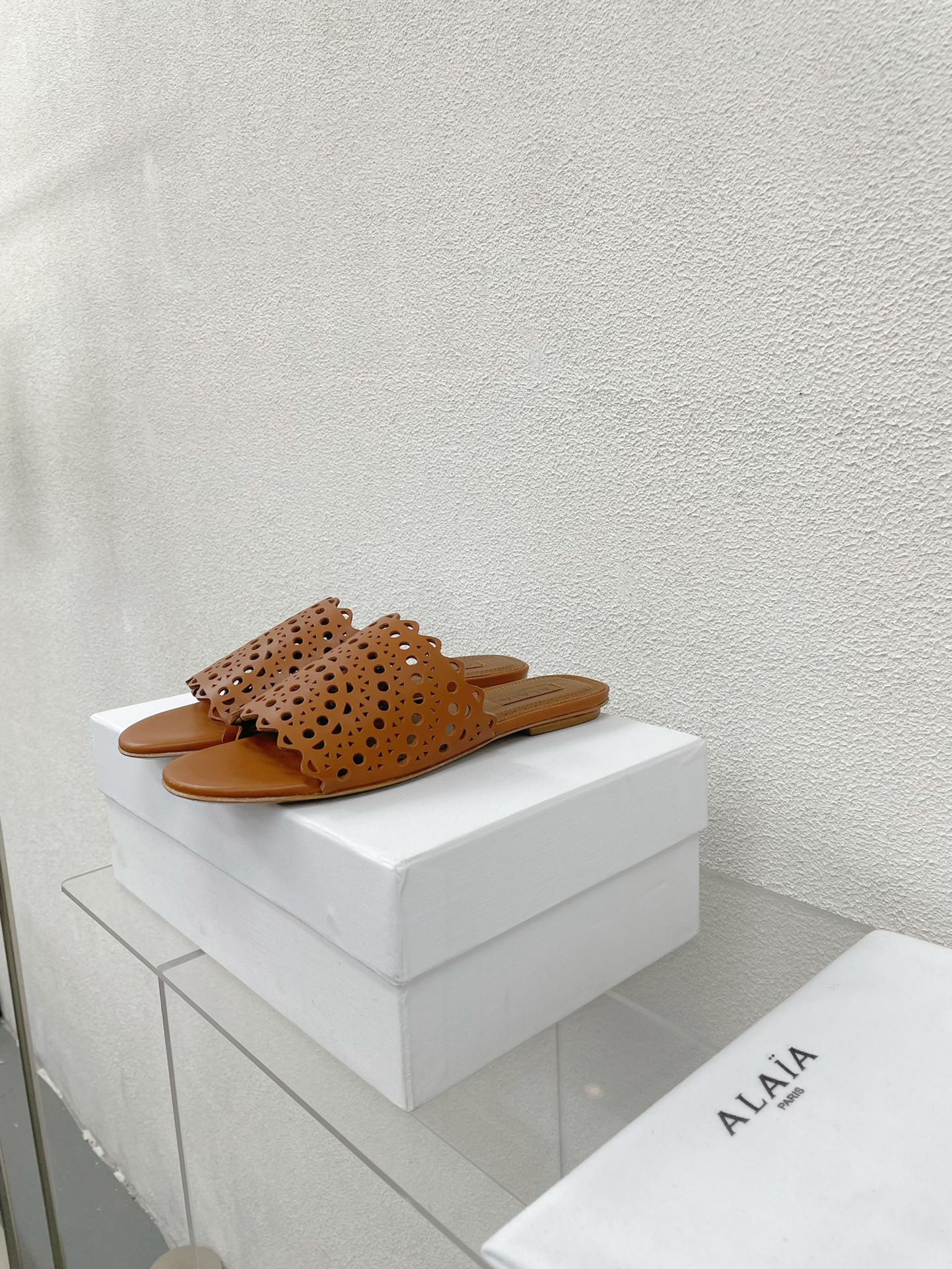 ALAIA VIENNE FLAT MULES IN CHOCOLATE BROWN LAMBSKIN