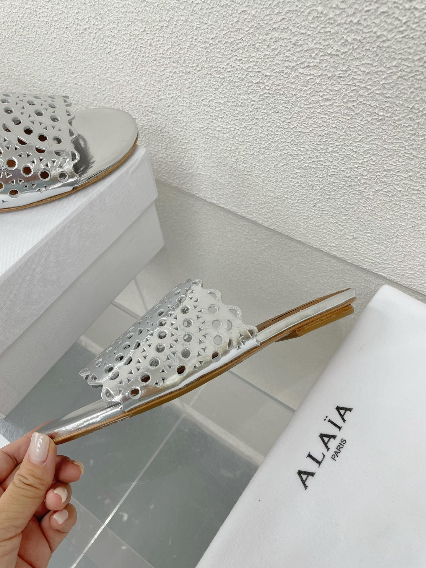 ALAIA VIENNE FLAT MULES IN SILVER LAMBSKIN