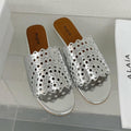 ALAIA VIENNE FLAT MULES IN SILVER LAMBSKIN