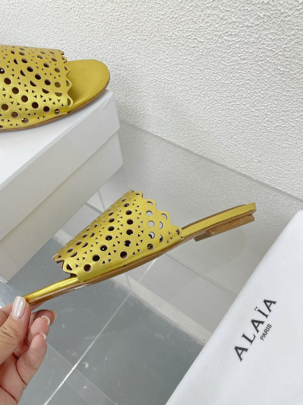 ALAIA VIENNE FLAT MULES IN GOLDEN LAMBSKIN