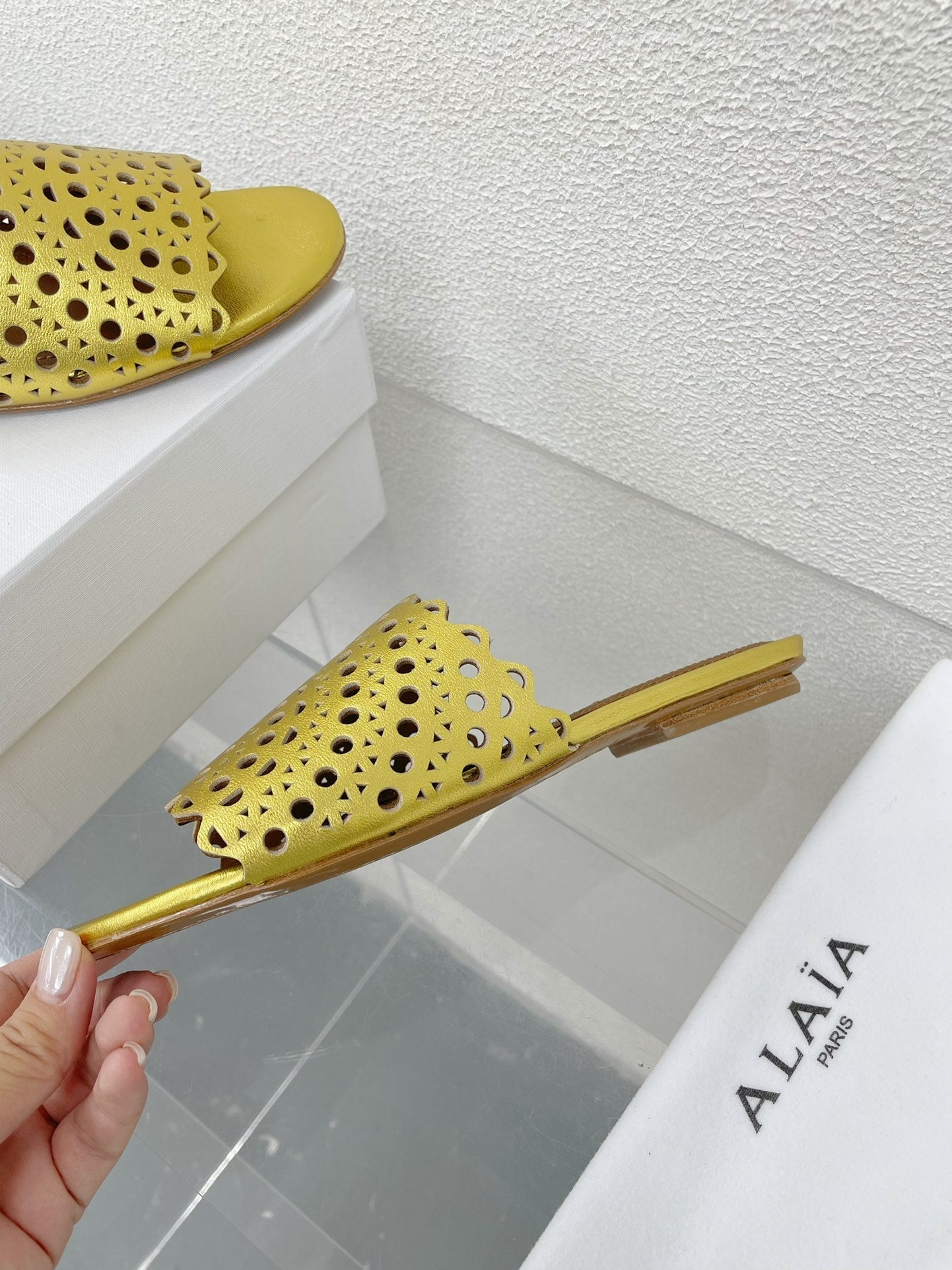 ALAIA VIENNE FLAT MULES IN GOLDEN LAMBSKIN