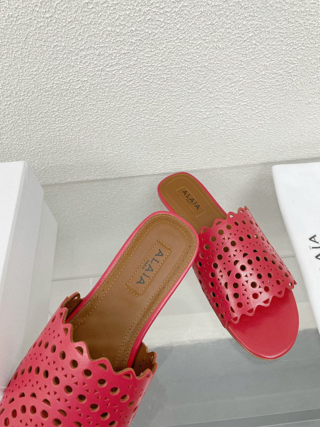 ALAIA VIENNE FLAT MULES IN CHERRY RED LAMBSKIN