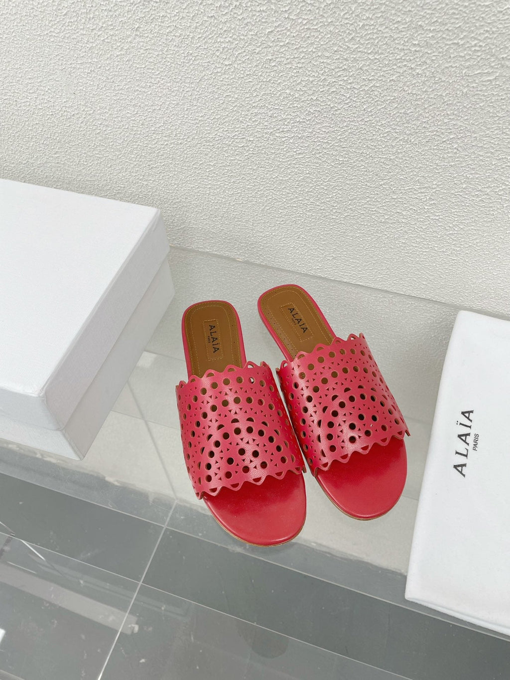 ALAIA VIENNE FLAT MULES IN CHERRY RED LAMBSKIN