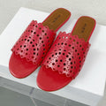 ALAIA VIENNE FLAT MULES IN CHERRY RED LAMBSKIN
