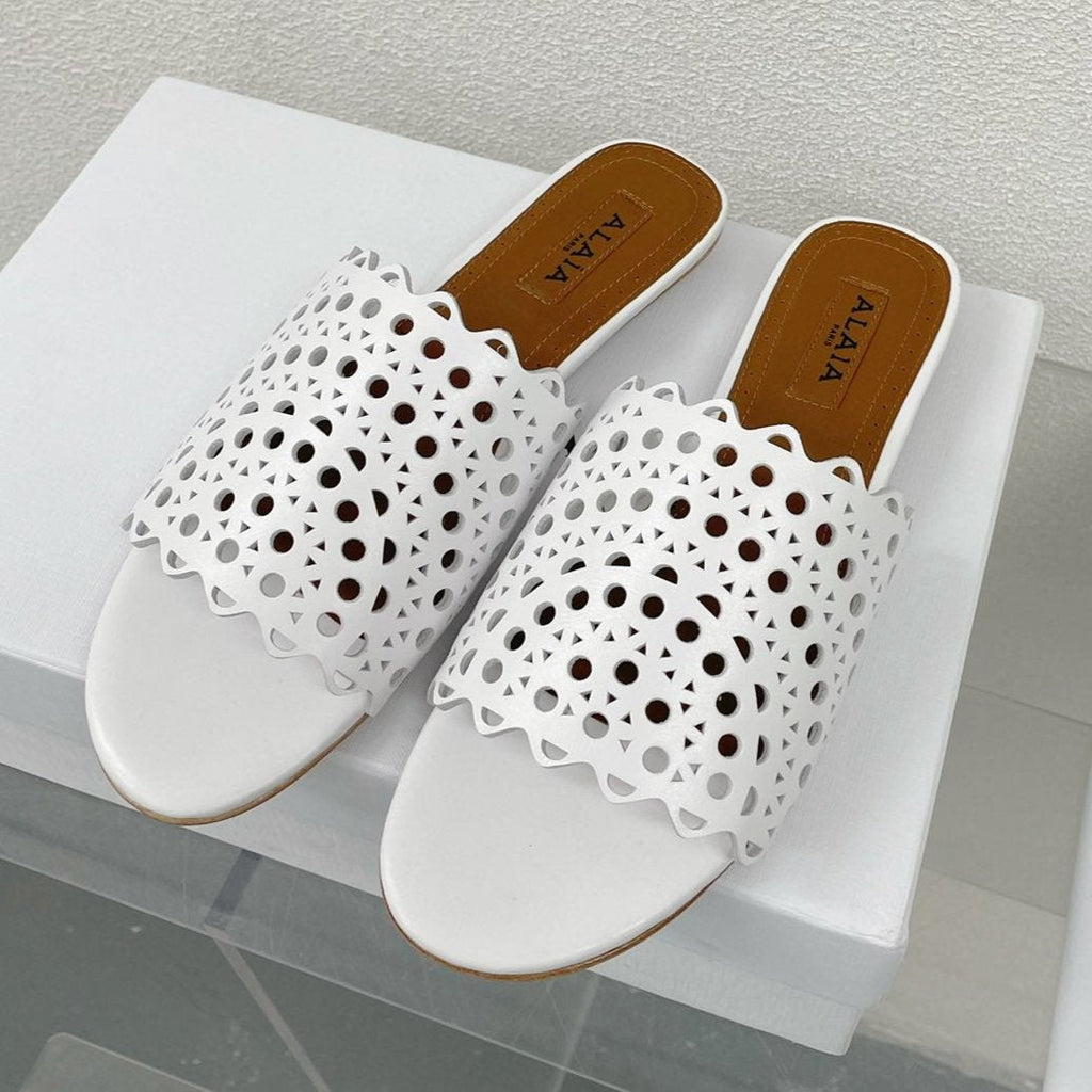 ALAIA VIENNE FLAT MULES IN WHITE LAMBSKIN