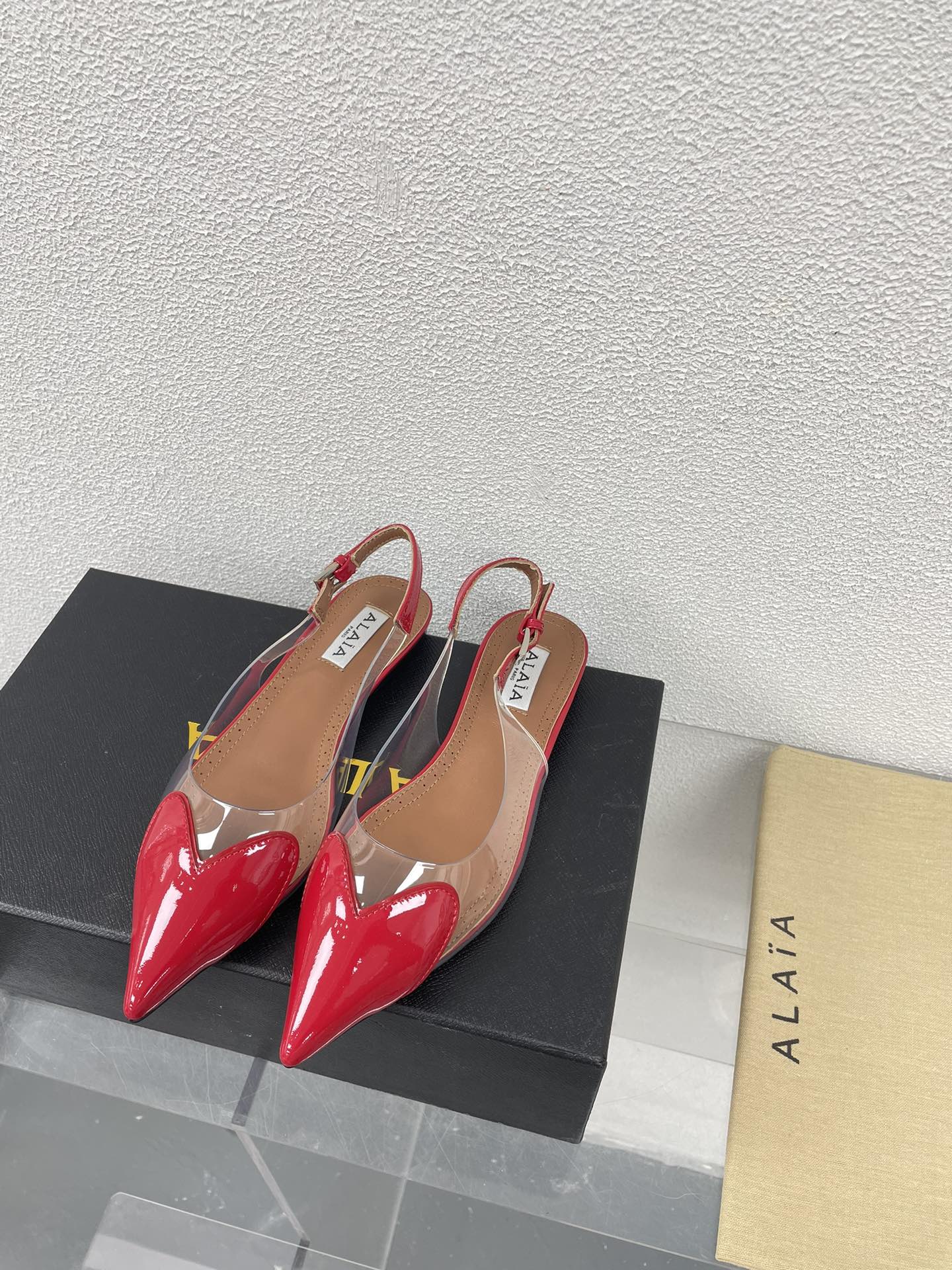 ALAIA LE COEUR FLAT SLINGBACKS IN CHERRY RED PATENT LAMBSKIN