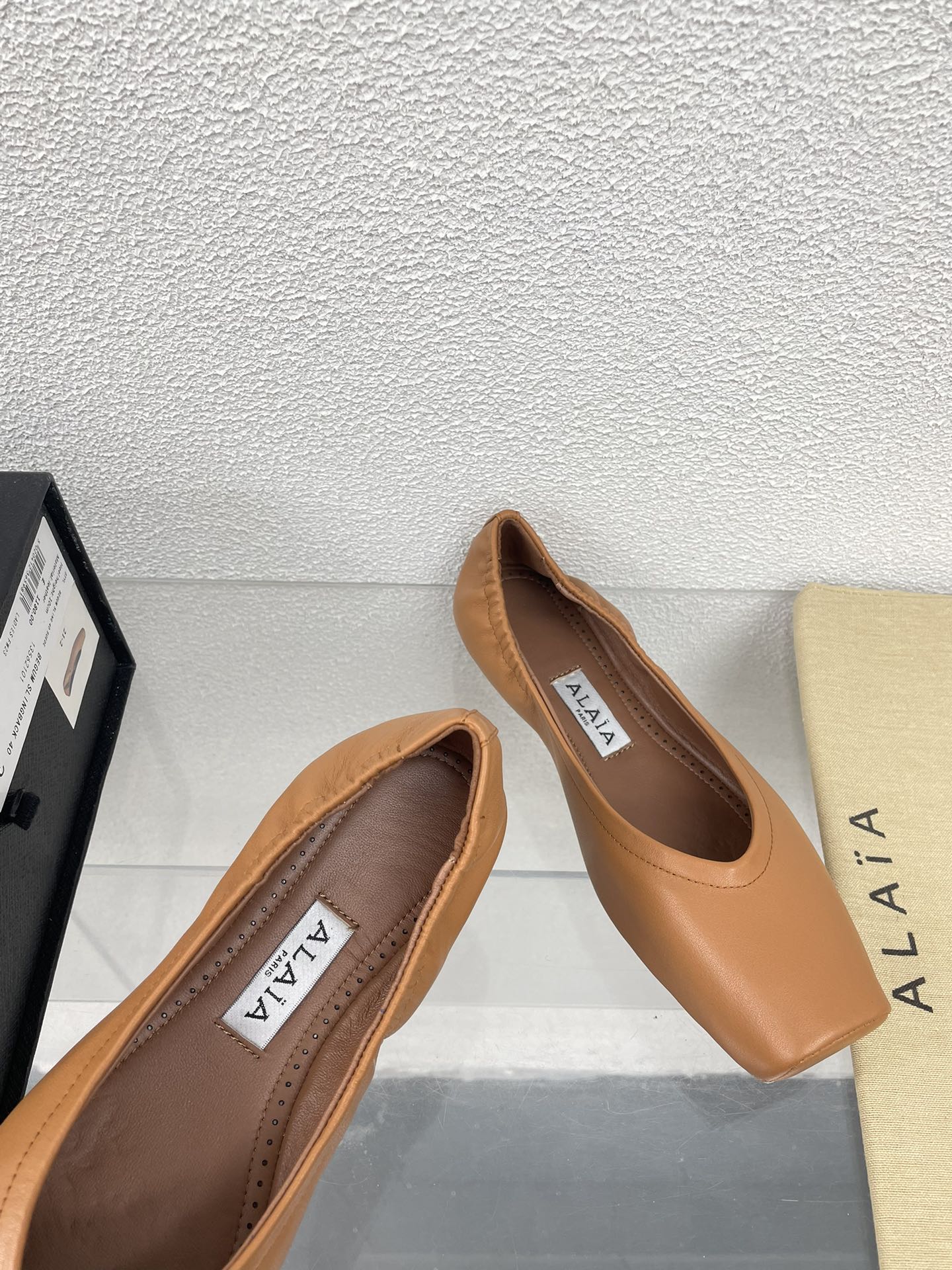 ALAIA BALLET FLATS IN COPPER BROWN CALFSKIN