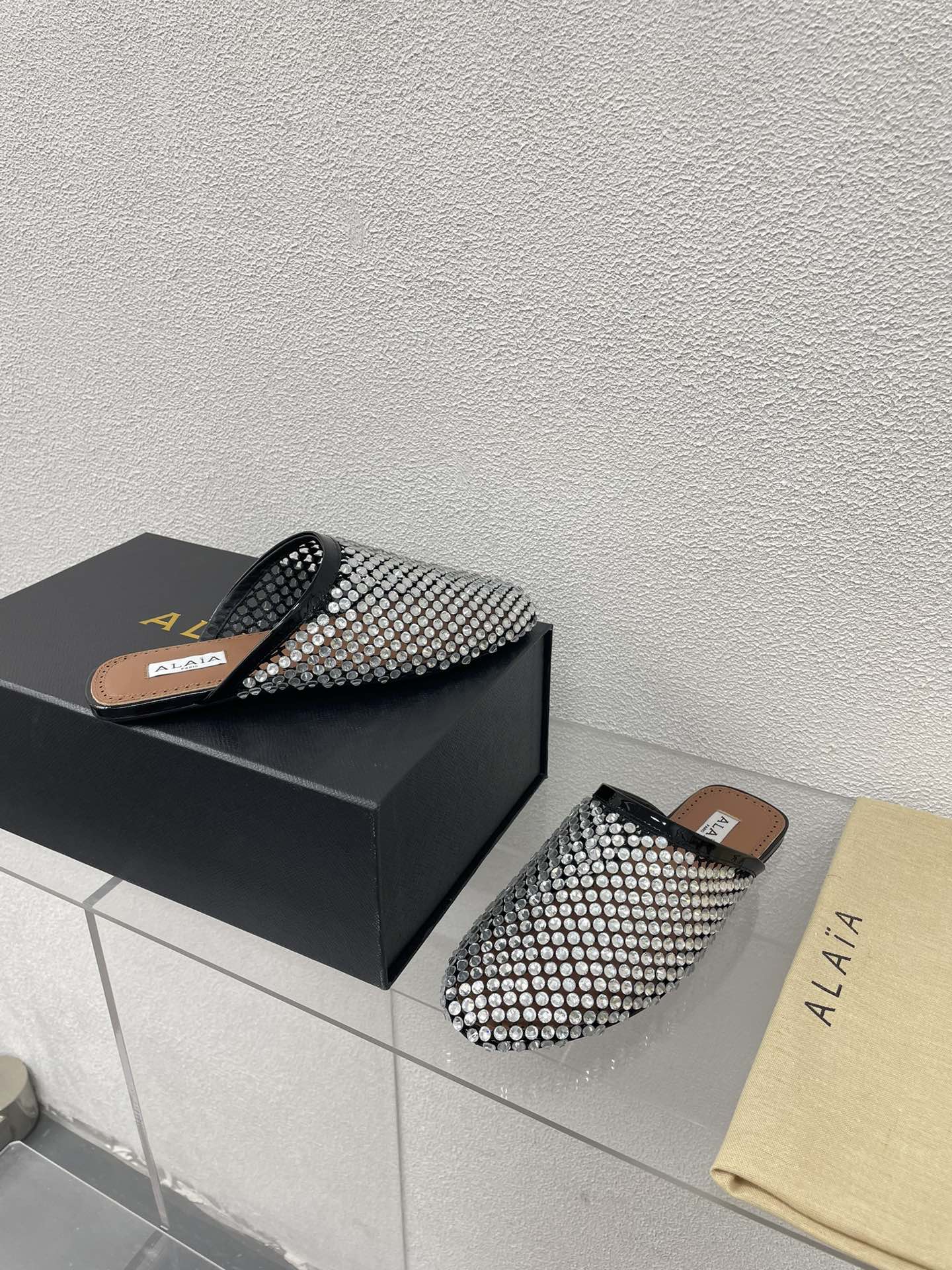 ALAIA FLAT MULES IN STRASS BLACK LAMBSKIN WITH RHINSTONES