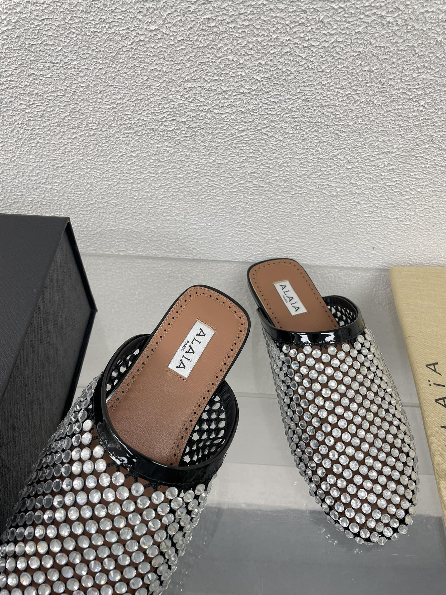 ALAIA FLAT MULES IN STRASS BLACK LAMBSKIN WITH RHINSTONES