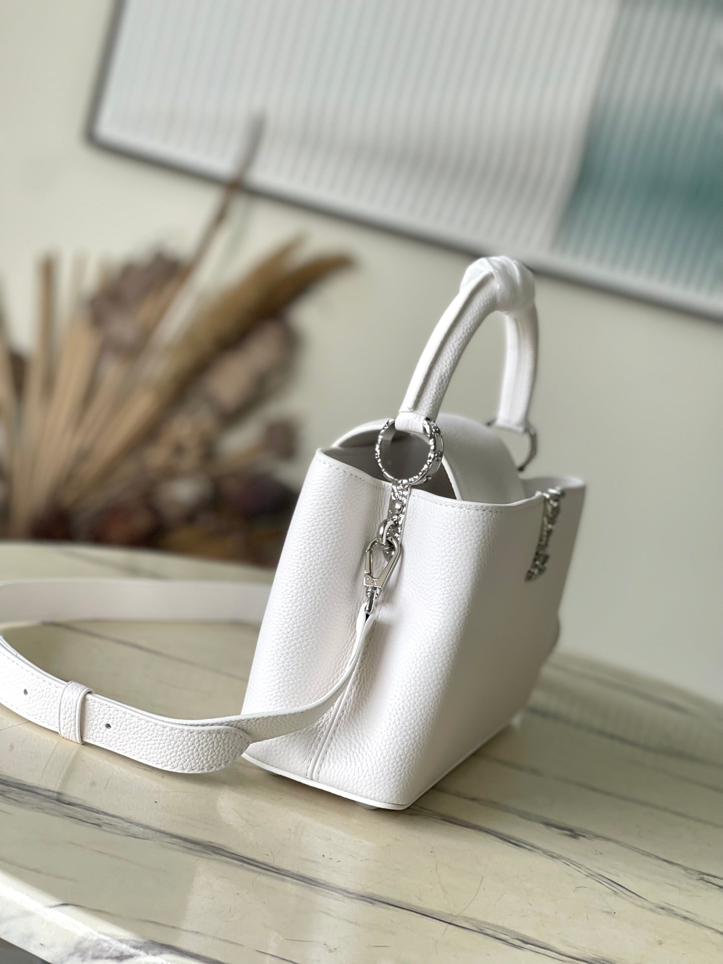 CAPUCINES EAST-WEST 33 IN WHITE CALFSKIN SILVER HARDWARE