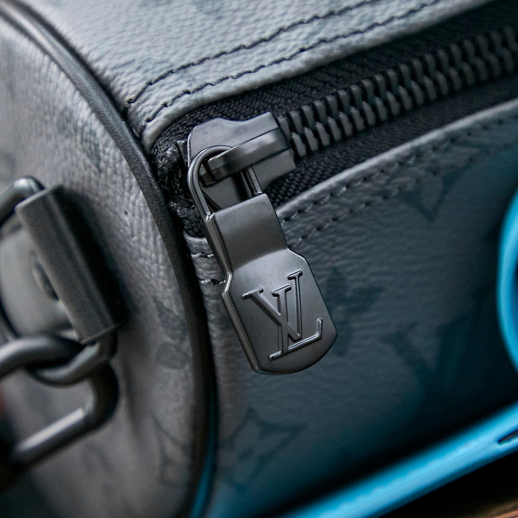 KEEPALL BANDOULIÈRE 25 IN GUN METAL MONOGRAM ECLIPSE CANVAS MIX TURQUOISE CALFSKIN