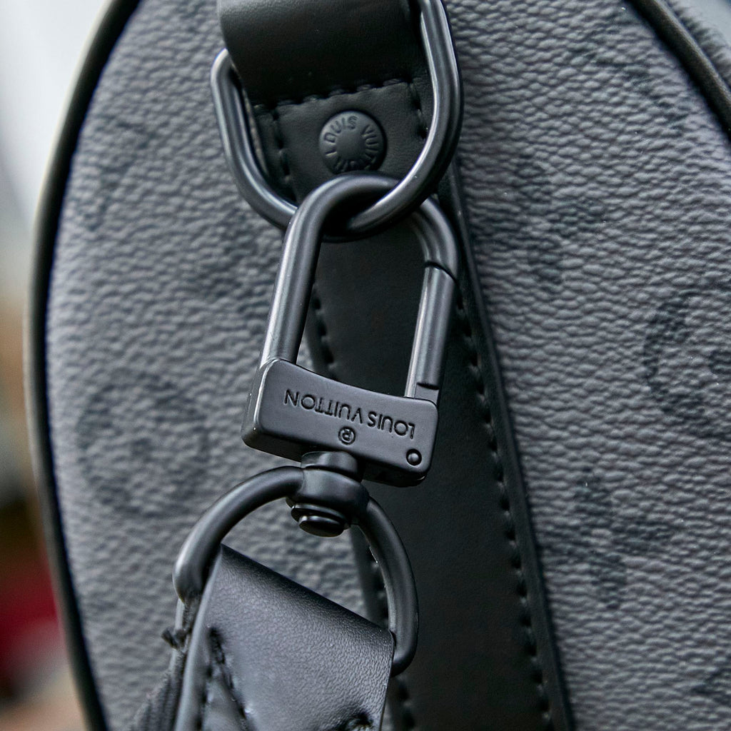 KEEPALL BANDOULIÈRE 25 IN GUN METAL MONOGRAM ECLIPSE CANVAS MIX TURQUOISE CALFSKIN