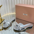 SLIDES SANDALS IN SILVER PATENT CALFSKIN BOW IN TRAP