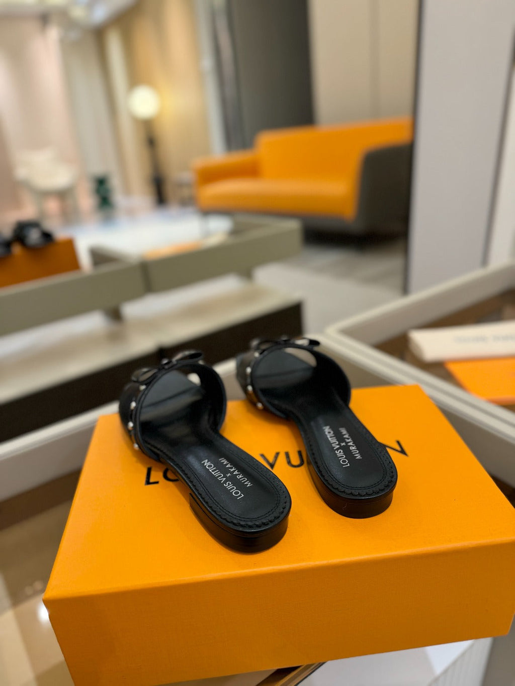 LV X TM 6AM FLAT MULE IN BLACK CALFSKIN