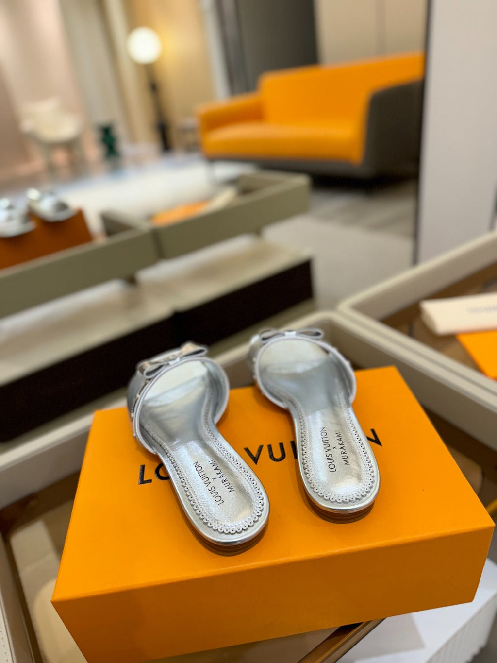 LV X TM 6AM FLAT MULE IN SILVER CALFSKIN
