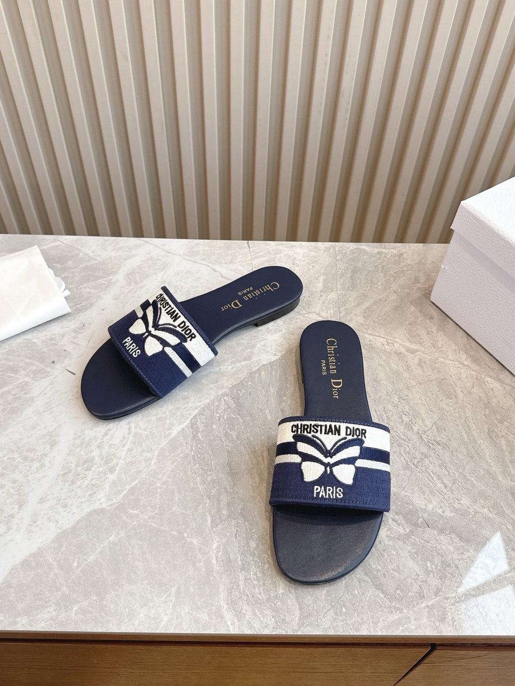DIOR FLAT SLIDES 25S IN MIDNIGHT BLUE CALFSKIN AND FABRIC EMBROIDERED BUTTERFLY MOTIF