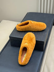 PRADA 25S CLOGS IN DARK ORANGE SHEARLING
