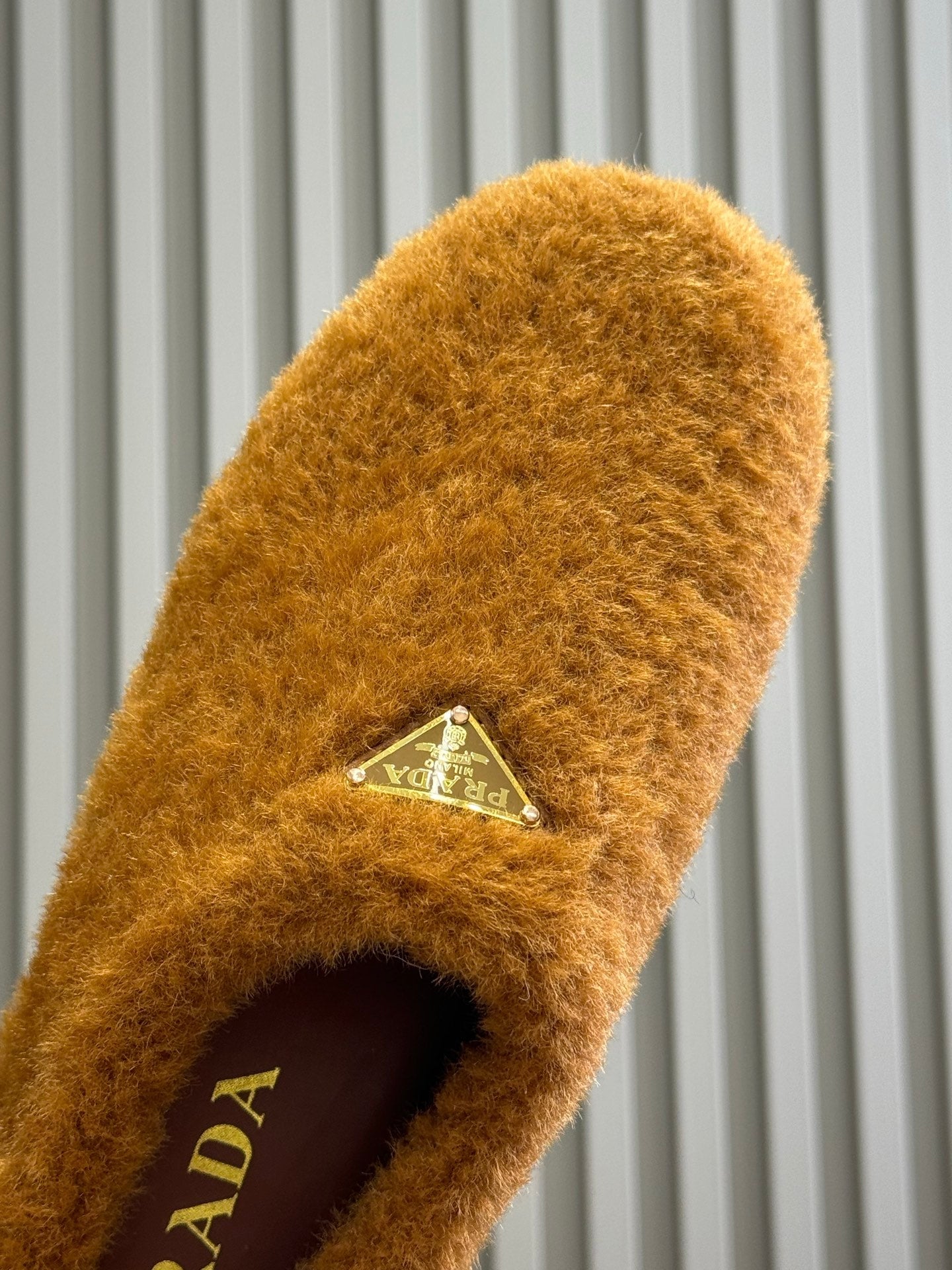 PRADA 25S CLOGS IN DARK ORANGE SHEARLING