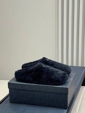 PRADA 25S CLOGS IN BLACK SHEARLING