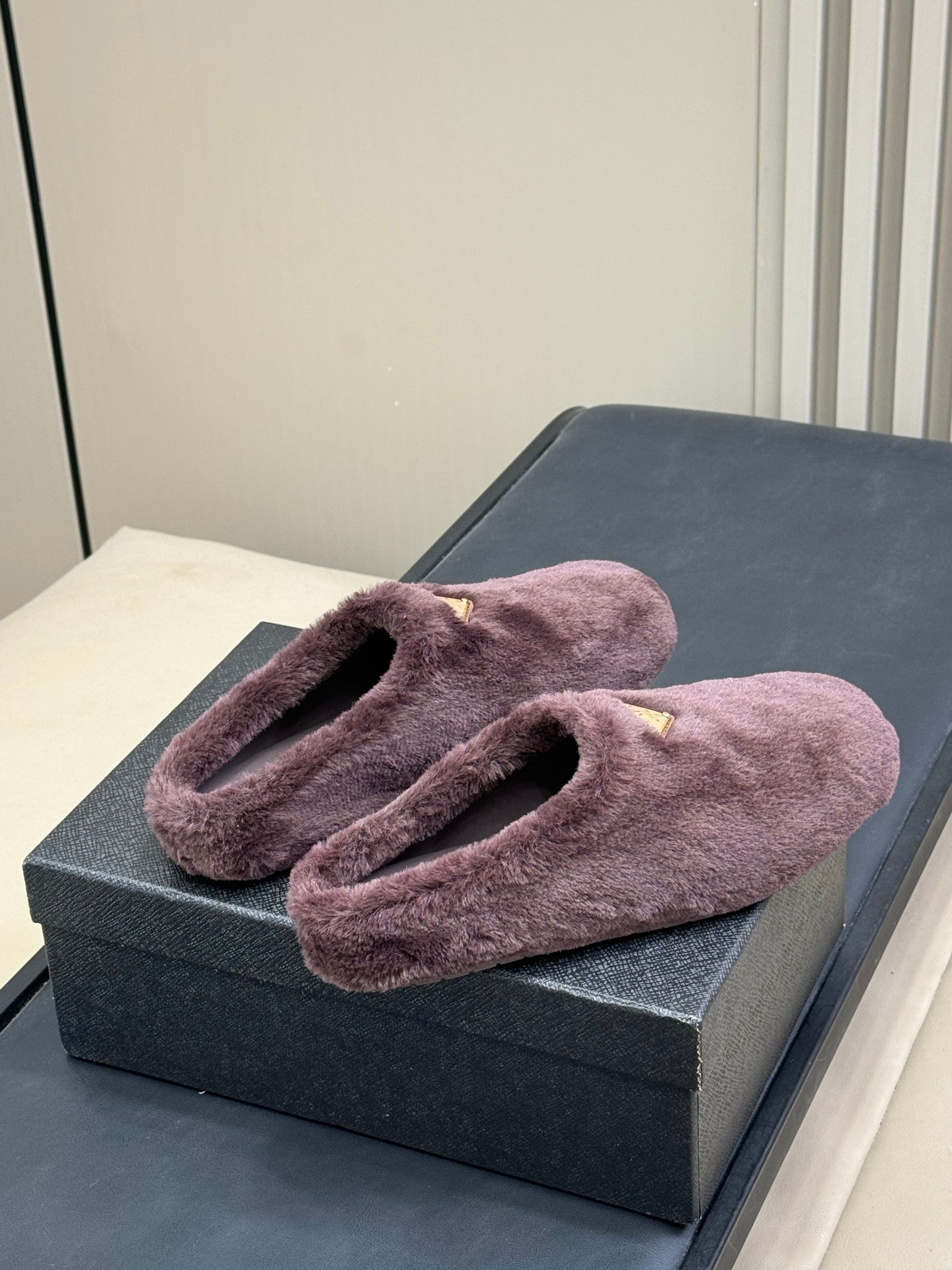 PRADA 25S CLOGS IN WINE RED SHEARLING